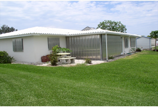 Home with Aluminum Hurricane Panels Installed